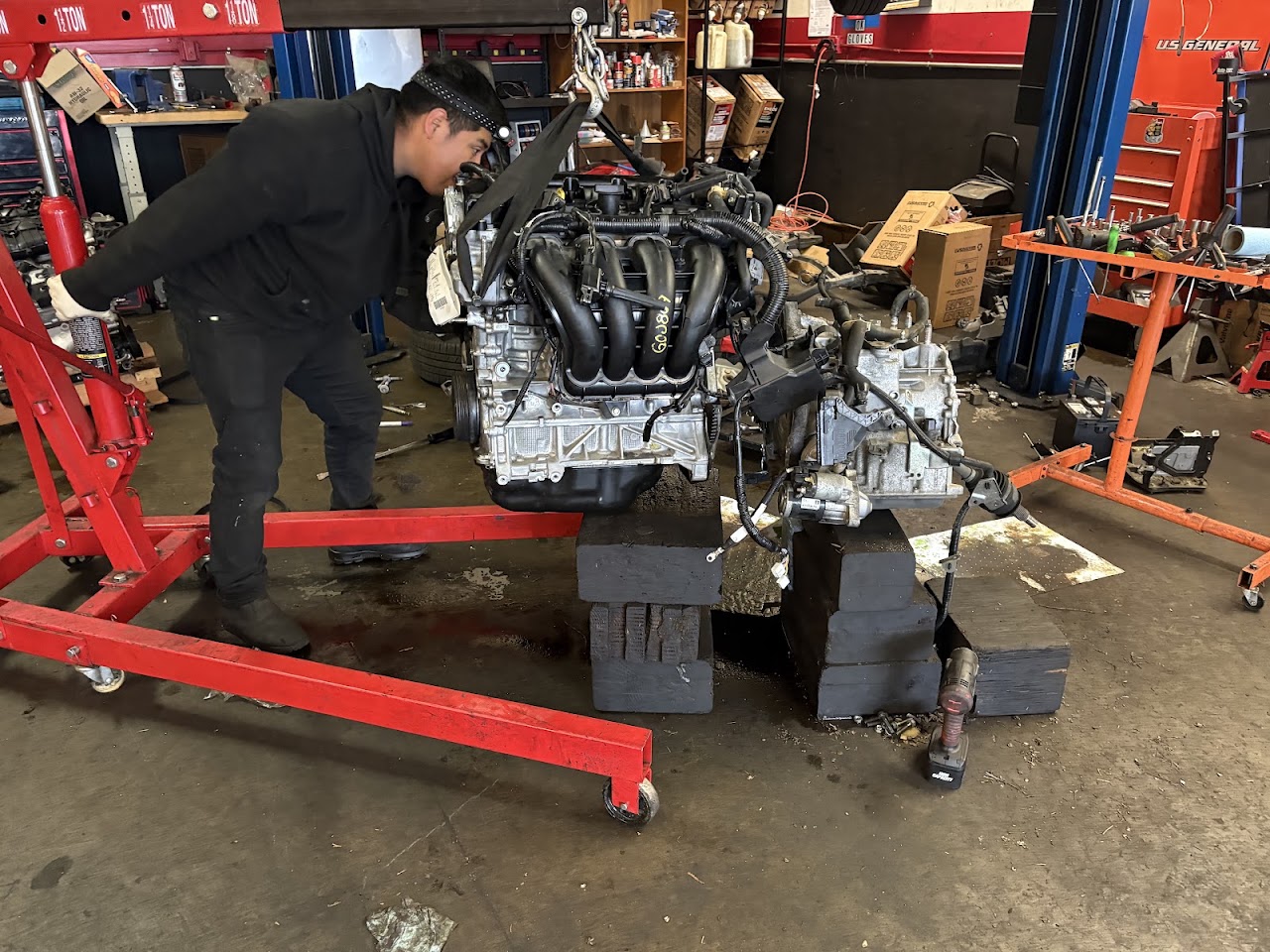 Technician inspecting an engine assembly at Joshua's Auto Repair